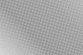 Frequent dotted halftone with subtle gradient. Black and white vector texture. Vintage effect graphic decor