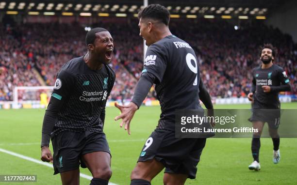 Georginio Wijnaldum of Liverpool celebrates with teammate after scoring his team's first goal during the Premier League match between Sheffield...
