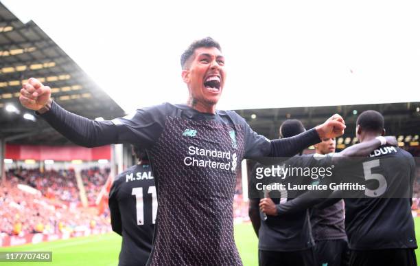 Roberto Firmino of Liverpool celebrates his team's first goal scored by Georginio Wijnaldum during the Premier League match between Sheffield United...