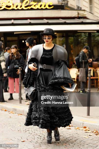 Guest wearing black fedora, puffy dress and lace up shoes outside the Altuzarra show during Womenswear Spring/Summer 2020 show Paris Fashion Week on...