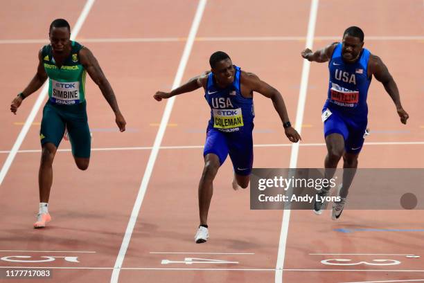 Christian Coleman of the United States crosses the finish line to win the Men's 100 Metres final ahead of Justin Gatlin of the United States and...