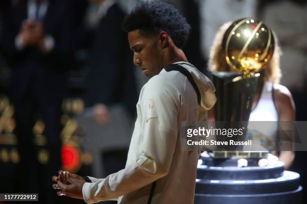 Toronto Raptors forward Patrick McCaw looks at his championship ring as the Toronto Raptors open the season against the New Orleans Pelicans with a...