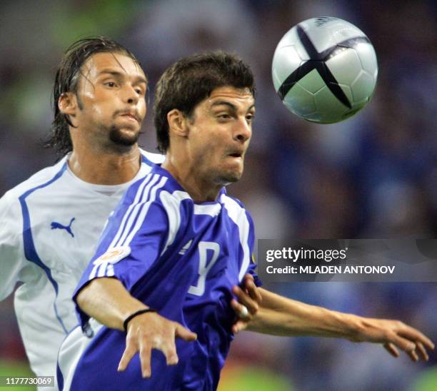 Greece's forward Angelos Charisteas heads the ball in front of Czech defender Marek Jankulovski, 01 July 2004 at the Do Dragao in Porto, during the...