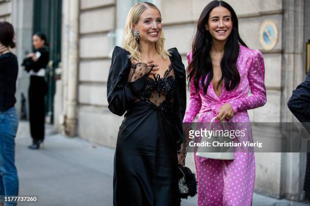 Leonie Hanne seen wearing black sheer dress and Tamara Kalinic wearing pink dress with dots print outside Alessandra Rich during Paris Fashion Week...