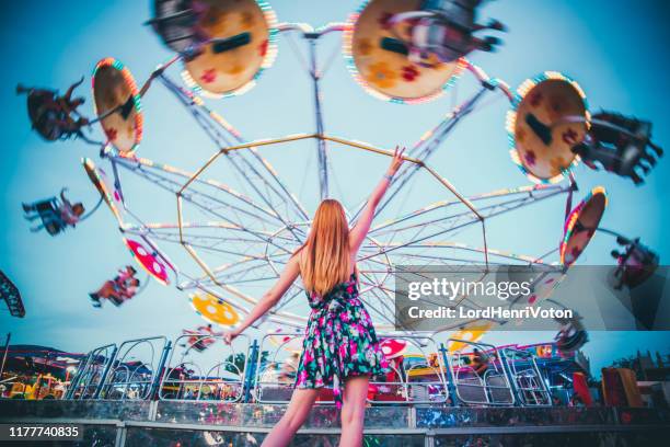 happy girl in amusement park - amusement park sign stock pictures, royalty-free photos & images