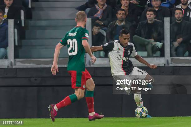 Vladislav Ignatyev of Lokomotiv Moskva and Alex Sandro of Juventus Turin battle for the ball during the UEFA Champions League group D match between...