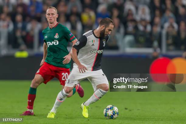 Vladislav Ignatyev of Lokomotiv Moskva and Leonardo Bonucci of Juventus Turin battle for the ball during the UEFA Champions League group D match...