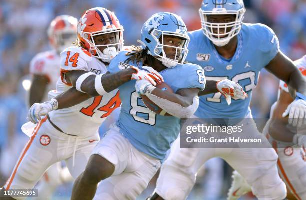 Denzel Johnson of the Clemson Tigers tackles Michael Carter of the North Carolina Tar Heels during the second half of their game at Kenan Stadium on...