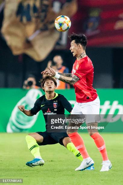 Zhang Linpeng of Guangzhou Evergrande fights for the ball with Takahiro Sekine of Urawa Red Diamonds in action during the AFC Champions League Semi...