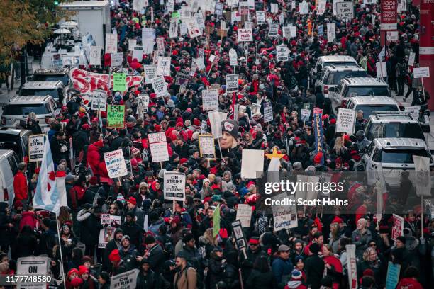 Thousands of demonstrators take to the streets, stopping traffic and circling City Hall in a show support for the ongoing teachers strike on October...