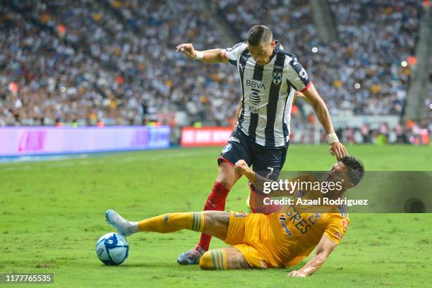 Rogelio Funes Mori, #7 of Monterrey, fights for the ball with Carlos Salcedo, #3 of Tigres, during the 12th round match between Monterrey and Tigres...