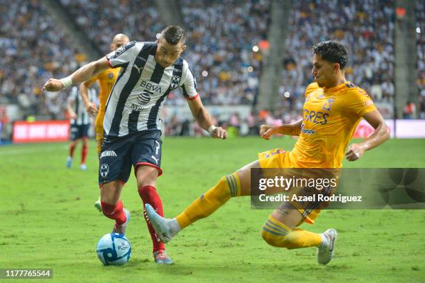 Rogelio Funes Mori, #7 of Monterrey, fights for the ball with Carlos Salcedo, #3 of Tigres, during the 12th round match between Monterrey and Tigres...