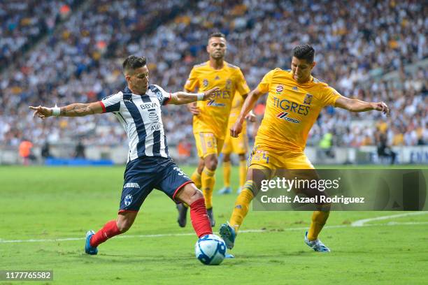 Maximiliano Meza, #32 of Monterrey, fights for the ball with Hugo Ayala, #4 of Tigres, during the 12th round match between Monterrey and Tigres UANL...