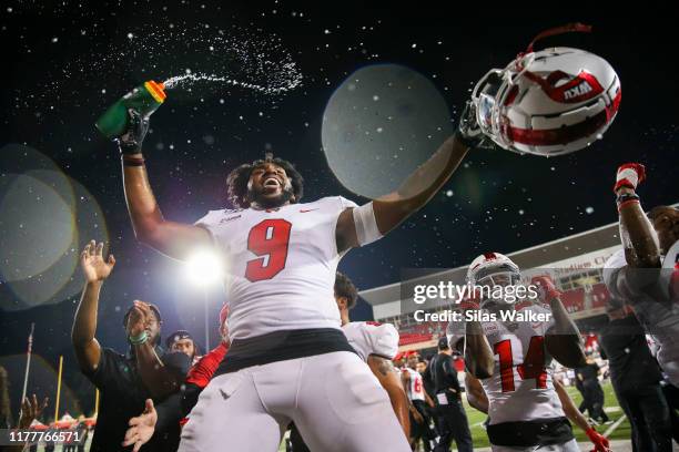 Malik Staples of the Western Kentucky University Hilltoppers sprays water while celebrating a victory against the University of Alabama Birmingham...