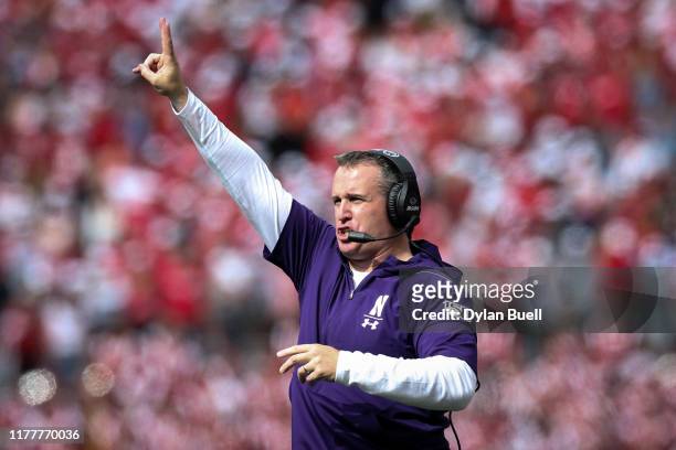 Head coach Pat Fitzgerald of the Northwestern Wildcats signals in the fourth quarter against the Wisconsin Badgers at Camp Randall Stadium on...