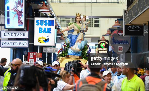 Local fishermen in procession with a replica statue of the Santa Maria Di Porto Salvo during the blessing of the fleet celebrations at Sydney Fish...