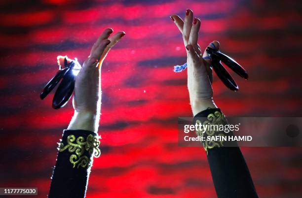 Close-up picture shows the hands of Spanish flamenco dancer Carolina Morgado using castanets as she performs on stage at the citadel of Arbil, the...