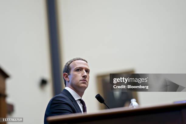 Mark Zuckerberg, chief executive officer and founder of Facebook Inc., listens during a House Financial Services Committee hearing in Washington,...