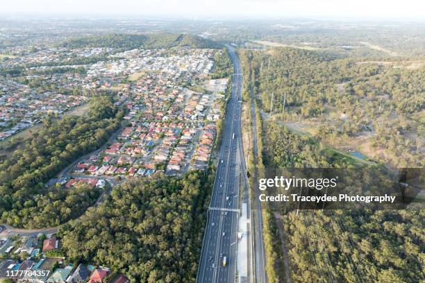 aerial shot of residential area and motorway in brisbane, queensland - brisbane street stock pictures, royalty-free photos & images