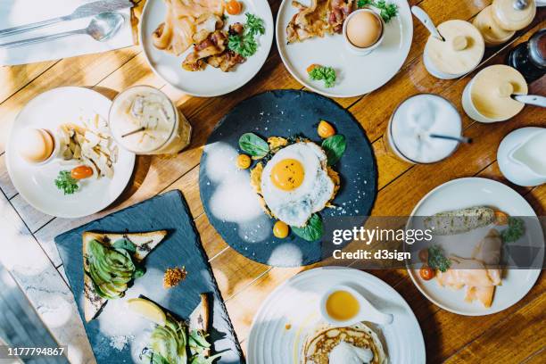 directly above view of brunch freshly served on table in an outdoor restaurant against beautiful sunlight - enjoying coffee cafe morning light stock pictures, royalty-free photos & images