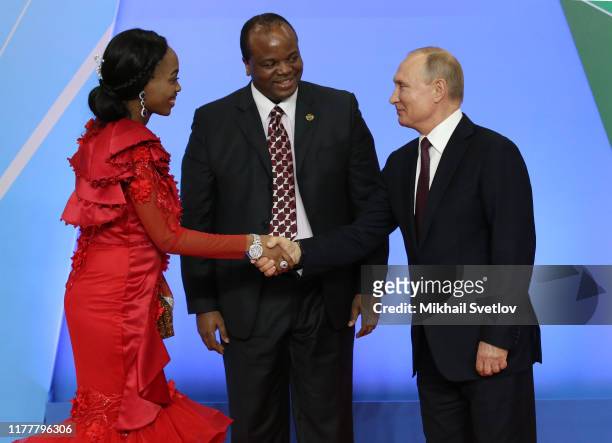 Russian President Vladimir Putin greets King Mswati III of Eswatini and his spouse during the welcoming ceremony at the Russia-Africa Summit in Black...