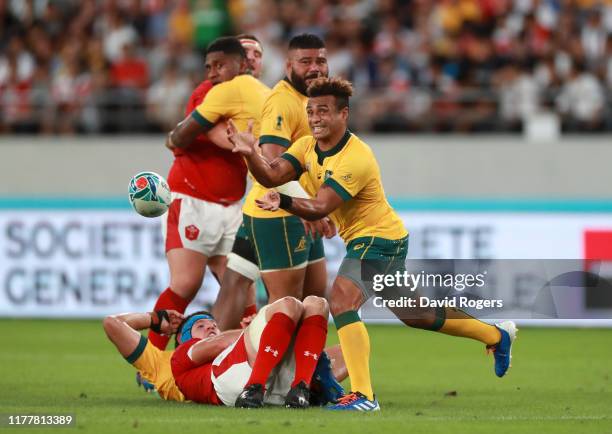 Will Genia of Australia offloads the ball during the Rugby World Cup 2019 Group D game between Australia and Wales at Tokyo Stadium on September 29,...