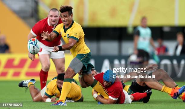 Will Genia of Australia offloads the ball during the Rugby World Cup 2019 Group D game between Australia and Wales at Tokyo Stadium on September 29,...