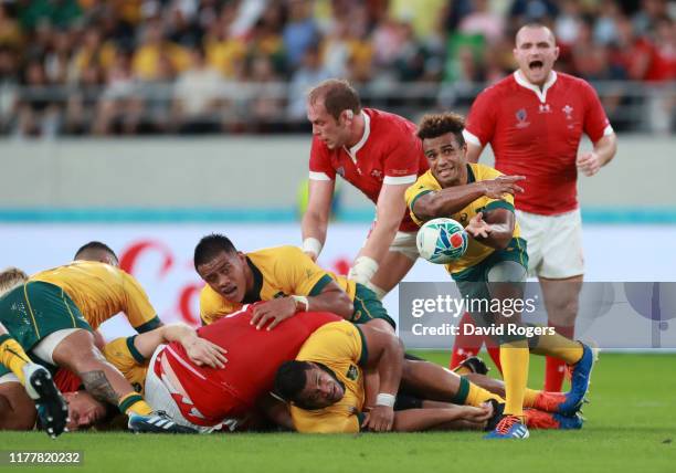 Will Genia of Australia offloads the ball during the Rugby World Cup 2019 Group D game between Australia and Wales at Tokyo Stadium on September 29,...