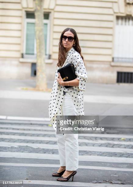 Erika Boldrin is seen wearing white pants, blouse with dots print, black bag outside Altuzarra during Paris Fashion Week Womenswear Spring Summer...
