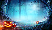 Jack O’ Lanterns In Spooky Forest At Moonlight - Halloween