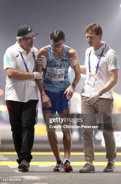 Medical staff attend to Maryan Zakalnytskyy of Ukraine in the Men’s 50km Race Walk final during day two of 17th IAAF World Athletics Championships...