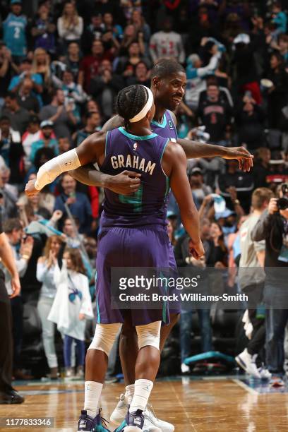 Marvin Williams of the Charlotte Hornets celebrates with Devonte' Graham during the game against the Chicago Bulls on October 23, 2019 at Spectrum...