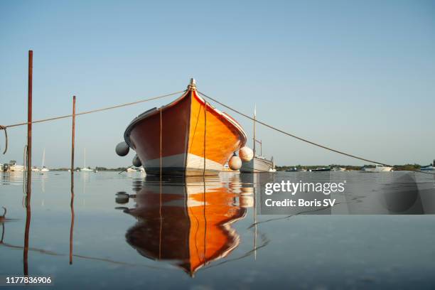 moored boat during high tide in arcachon bay, france - arcachon stock pictures, royalty-free photos & images