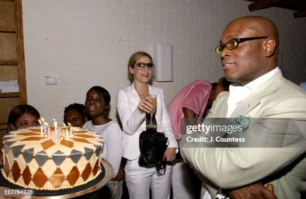 Erica Reid presents the birthday to Antonio "LA" Reid