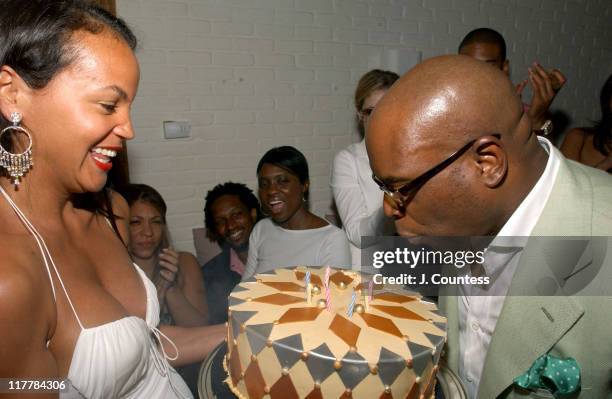 Erica Reid with Antonio "LA" Reid as he blows out candles on his birthday cake