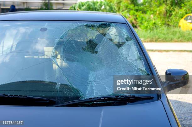 broken car windshield in car accident. - glass shatter stock-fotos und bilder