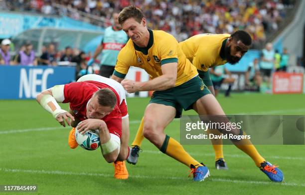 Hadleigh Parkes of Wales dives over to score their first try despite being held by Dane Haylett-Petty during the Rugby World Cup 2019 Group D game...