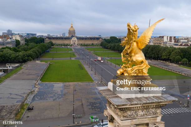 This aerial view taken on July 9 shows the gilded bronze statue of the French sculptor Pierre Granet "La Renomée au Combat" depicting a woman with a...