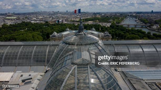 This aerial view taken on July 8 shows the glass barrel-vaulted roof of the Grand Palais, built in 1900 for the Universal Exhibition, with the Hotel...