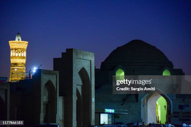 tim abdulla khan trading dome and kalyan minaret at night - uzbekistan market stock pictures, royalty-free photos & images
