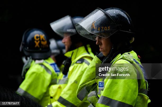 Mounted Police officers look on as protesters take part in a large scale demonstration against austerity and the Conservative government on September...