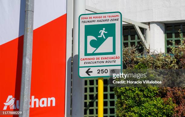 Sign indicates the evacuation route in case of tsunami in the corner of Sintra and Marginal avenues on September 29, 2019 in Cascais, Portugal. The...