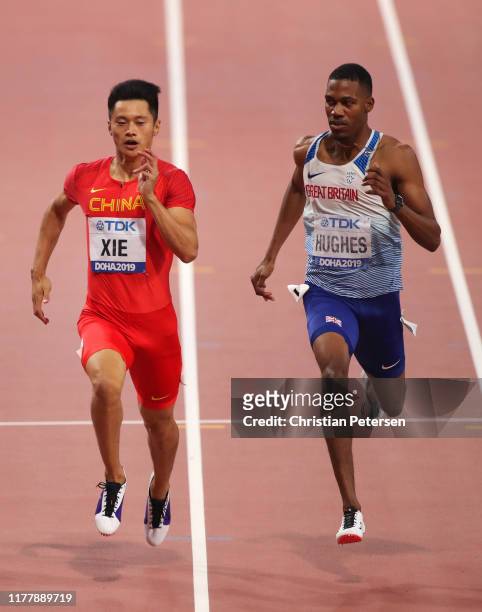 Zhenye Xie of China and Zharnel Hughes of Great Britain compete in the Men's 200 Metres heats during day three of 17th IAAF World Athletics...