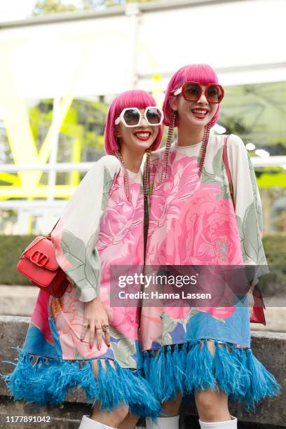 Ami Suzuki and Aya Suzuki of Amiaya wearing Valentino dress and bag outside Valentino during Paris Fashion Week Womenswear Spring Summer 2020 on...