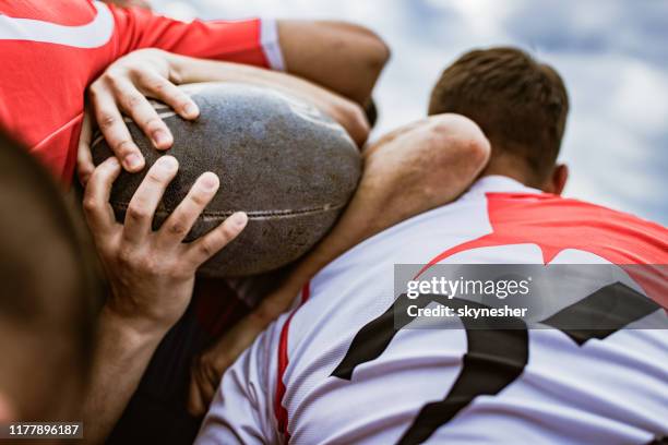 close up of unrecognizable athletes during rugby match. - rugby league scrum stock pictures, royalty-free photos & images