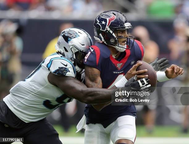 Deshaun Watson of the Houston Texans is sacked by Mario Addison of the Carolina Panthers during the first half at NRG Stadium on September 29, 2019...