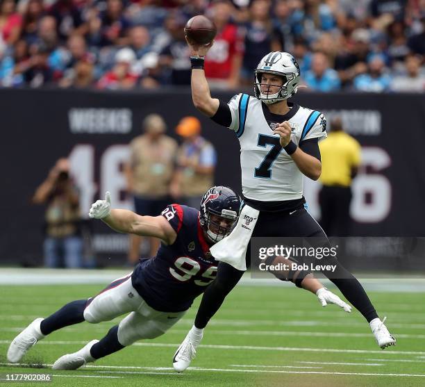 Kyle Allen of the Carolina Panthers scrambles out of the pocket looking for a receiver as he is pressured by J.J. Watt of the Houston Texans during...