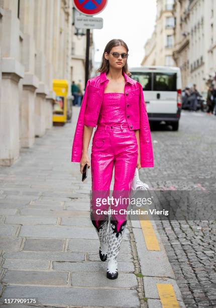 Model is seen wearing pink jacket and pants, Cowboy boots, white bag outside Altuzarra during Paris Fashion Week Womenswear Spring Summer 2020 on...