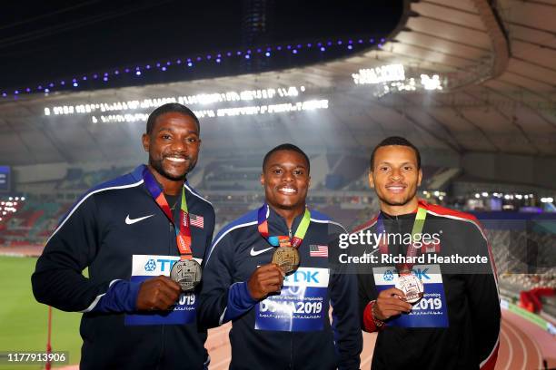 Christian Coleman of the United States, gold, Justin Gatlin of the United States, silver, and Andre De Grasse of Canada, bronze, pose during the...