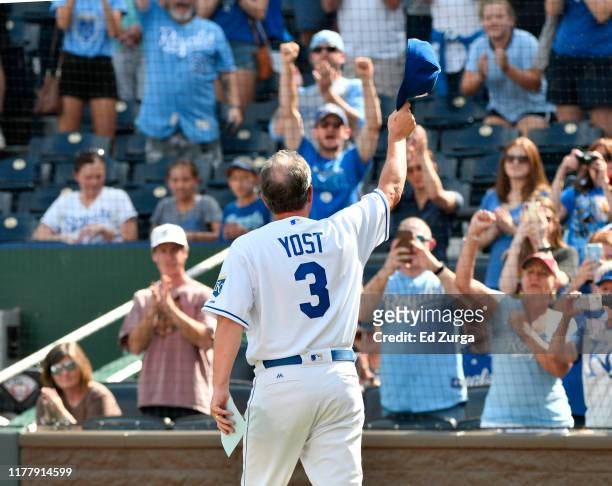 Manager Ned Yost of the Kansas City Royals waves to the crowd after bringing out the lineup before a game against the Minnesota Twins at Kauffman...